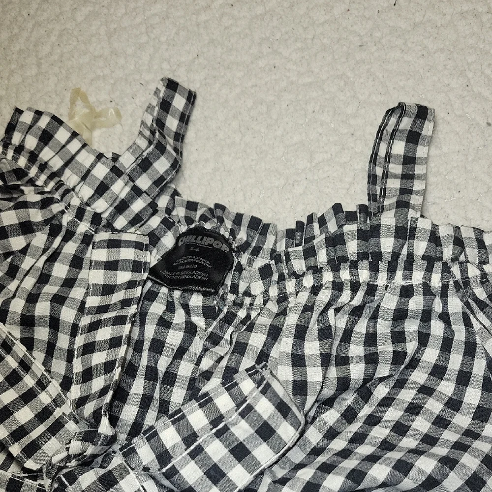 Charming Black and White Checkered Romper with Floral Detail - Picture 4 of 5